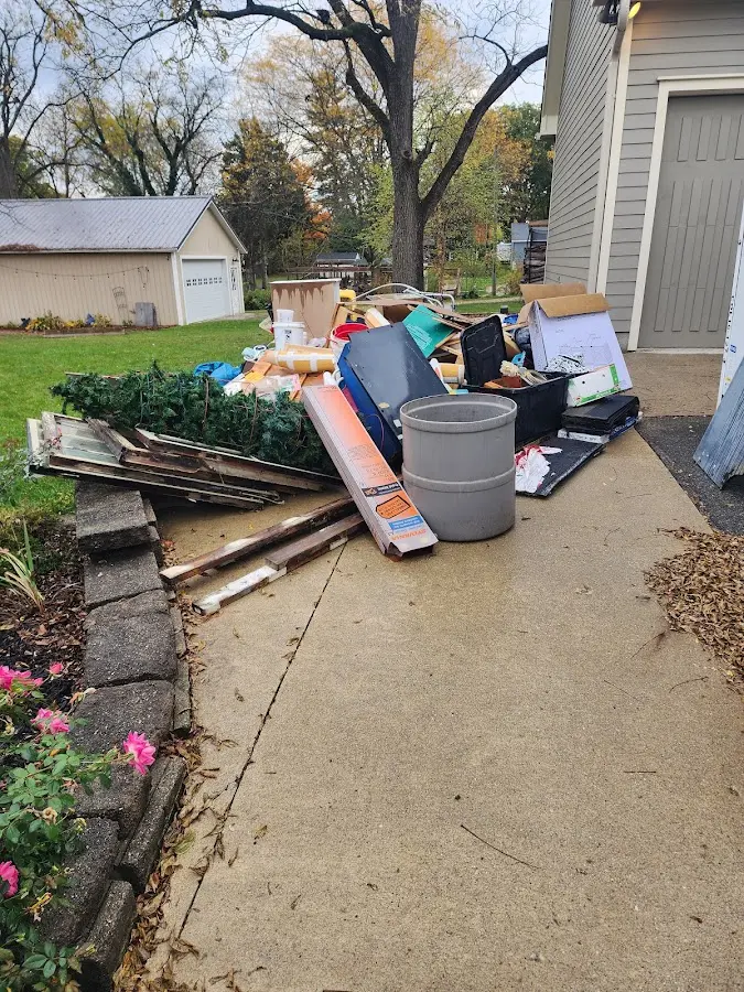 Dumpster being loaded with debris for Roofing Dumpster Rental in Busti